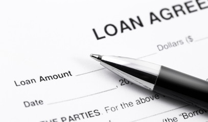 personal loan application form with black pen closeup macro