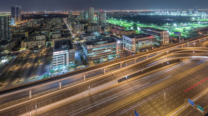 Fototapeta na wymiar Tecom, Barsha and Greens districts aerial view from Internet city night timelapse