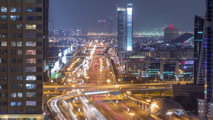 Fototapeta na wymiar Skyline internet city with crossing Sheikh Zayed Road aerial night timelapse