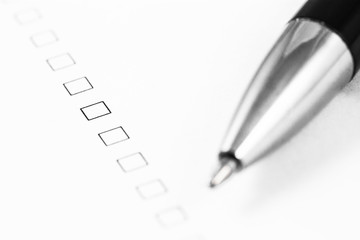 closeup black pen and paperwork with text Vote