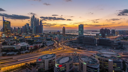 Naklejka na ściany i meble Dubai Media City with Modern buildings aerial day to night timelapse, United Arab Emirates