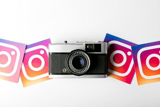 OXFORD, UK - NOVEMBER 30th 2016: Instagram logos printed onto paper with a retro vintage film camera. Instagram is a popular social media application for sharing images and videos