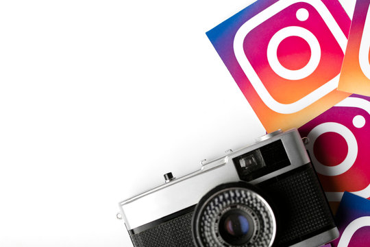 OXFORD, UK - NOVEMBER 30th 2016: Instagram logos printed onto paper with a retro vintage film camera. Instagram is a popular social media application for sharing images and videos