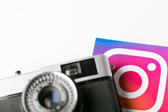 OXFORD, UK - NOVEMBER 30th 2016: Instagram logos printed onto paper with a retro vintage film camera. Instagram is a popular social media application for sharing images and videos