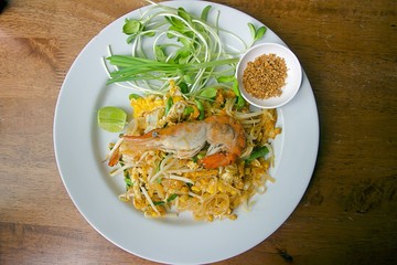 Thai food Pad thai , Stir fry noodles with shrimp on white plate.