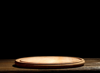 Wooden table background with black wall. Empty space for decoration and products.