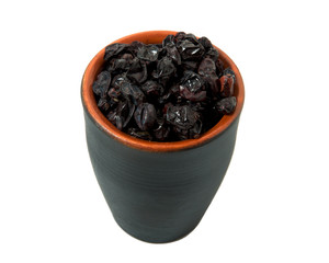 Dried barberry in a bowl isolated on a white background. Seasoning on isolate. View from above. Close up view of dried barberry.
