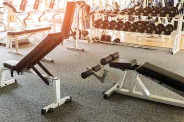 Bench in gym with dumbbells