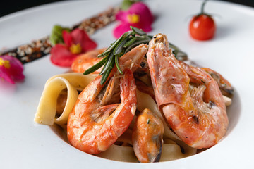 Seafood pasta mussel shrimp on a white plate