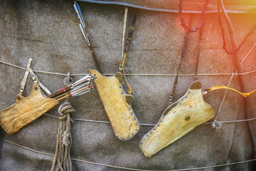 Quivers with vintage bows hanging on the wall. Weapons for hunting and tribal wars of ancient times.