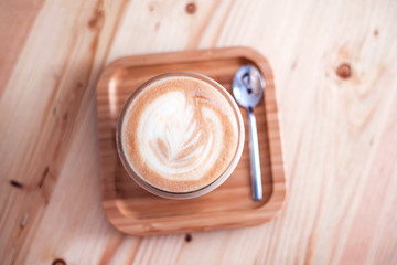 Fresh flavored coffee art on wooden background.