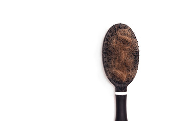 Comb brush hair with hair loss on white background. Copy space.