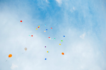 balloons flying in the sky among the clouds. Festive background