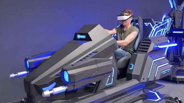 Handsome kinky Caucasian guy riding a car in virtual reality. Attractive, neon, auto, unreal, play, have fun, drive, emotions