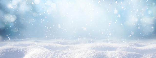 Winter snow background with snowdrifts, with beautiful light and snow flakes on the blue sky,...