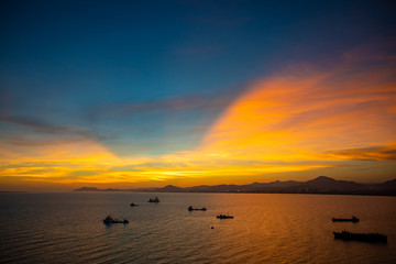 Obraz premium Fishing boats on sea in sunset lights in Sanya, Hainan, China