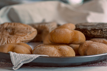 Cheese head on the table. Farm Cheese Plate. Ripe cheese made from goat and sheep’s milk.