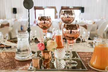table setting in rose gold with candles and fresh flowers