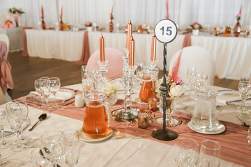 table setting in rose gold with candles and fresh flowers
