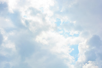 Bright and colorful photos of heavenly angelic white clouds and blue, blue sky with sunlight. Light, delicate and airy cloudy background with white and blue lights and colors.