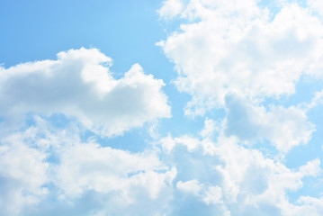 Bright and colorful photos of heavenly angelic white clouds and blue, blue sky with sunlight. Light, delicate and airy cloudy background with white and blue lights and colors.