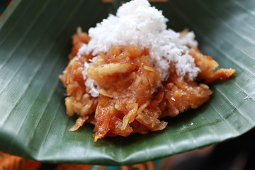 Sawut, a traditional snack made from grated cassava mixed with palm sugar and then steamed, eaten with grated coconut