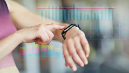 Frau kontrolliert Messwerte an Smart Watch