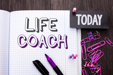 Handwriting text Life Coach. Concept meaning Mentoring Guiding Career Guidance Encourage Trainer Mentor written Notebook Book wooden background Today with Thumbpin Marker Paper Clip.
