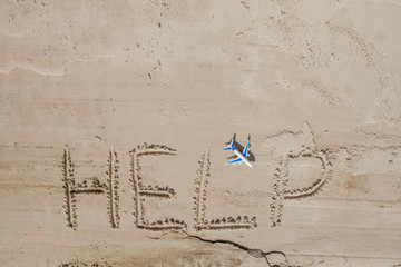 Help me the inscription and plane on the sand. Please help me. On a tropical beach