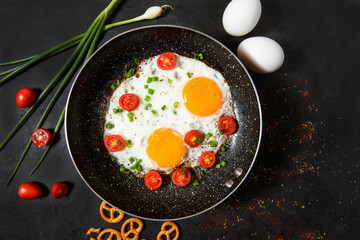 fried eggs with cherry tomatoes