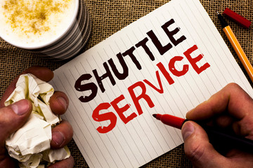 Writing note showing Shuttle Service. Business photo showcasing Transportation Offer Vacational Travel Tourism Vehicle written by Man Holding Marker Notebook Book the jute background