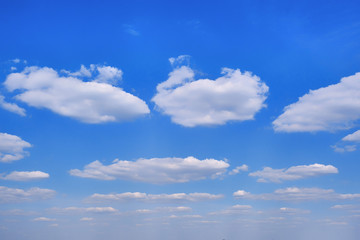 Clouds against a clear religious sky. Sunny day with floating symmetry white cloud. Background in the form of a symmetric cloudy sky.