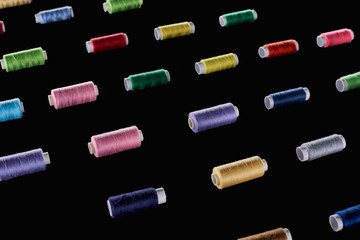 blue, gray, green, pink, purple, red, yellow threads isolated on black