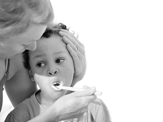 child brushing teeth with mother at home on white background stock photo