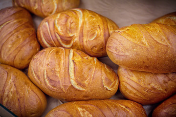 Freshly baked homemade bread with golden crispy crust. Food background.