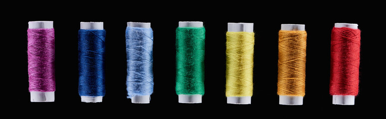 panoramic shot of bright and colorful threads isolated on black
