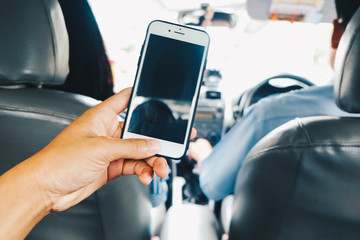 Hand using smartphone in taxi car blank screen