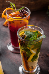 Two glasses of tea with fruits and spices. Hot drinks