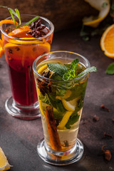 Two glasses of tea with fruits and spices. Hot drinks