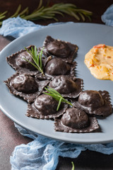 Ravioli with stuffing and gravy. Italian food