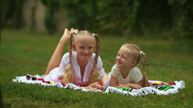 Two girls sisters posing in the summer on a sunny day. Best friends    
