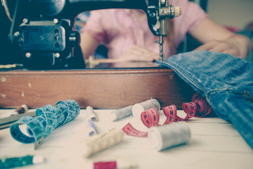 woman tailor using retro sewing machine