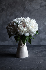 Beautiful peonies on grey concrete background. Wedding, birthday, valentine's day, gift or women's day concept