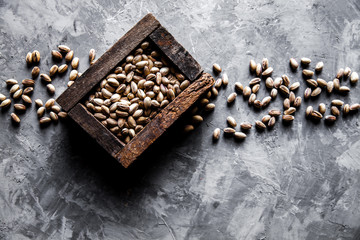 Pistachios nuts in wooden box. Top view