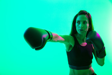 Beautiful young fitness girl standing isolated over background