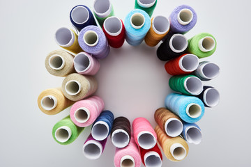 top view of bright and colorful threads on white background