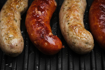 grilled sausages on hot grill pan. top view