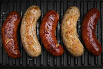 grilled sausages on hot grill pan. top view