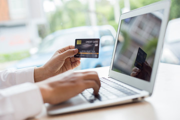 her are buying products online by paying via credit cards, online shopping and technology concept