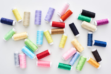 top view of bright and colorful threads on white background